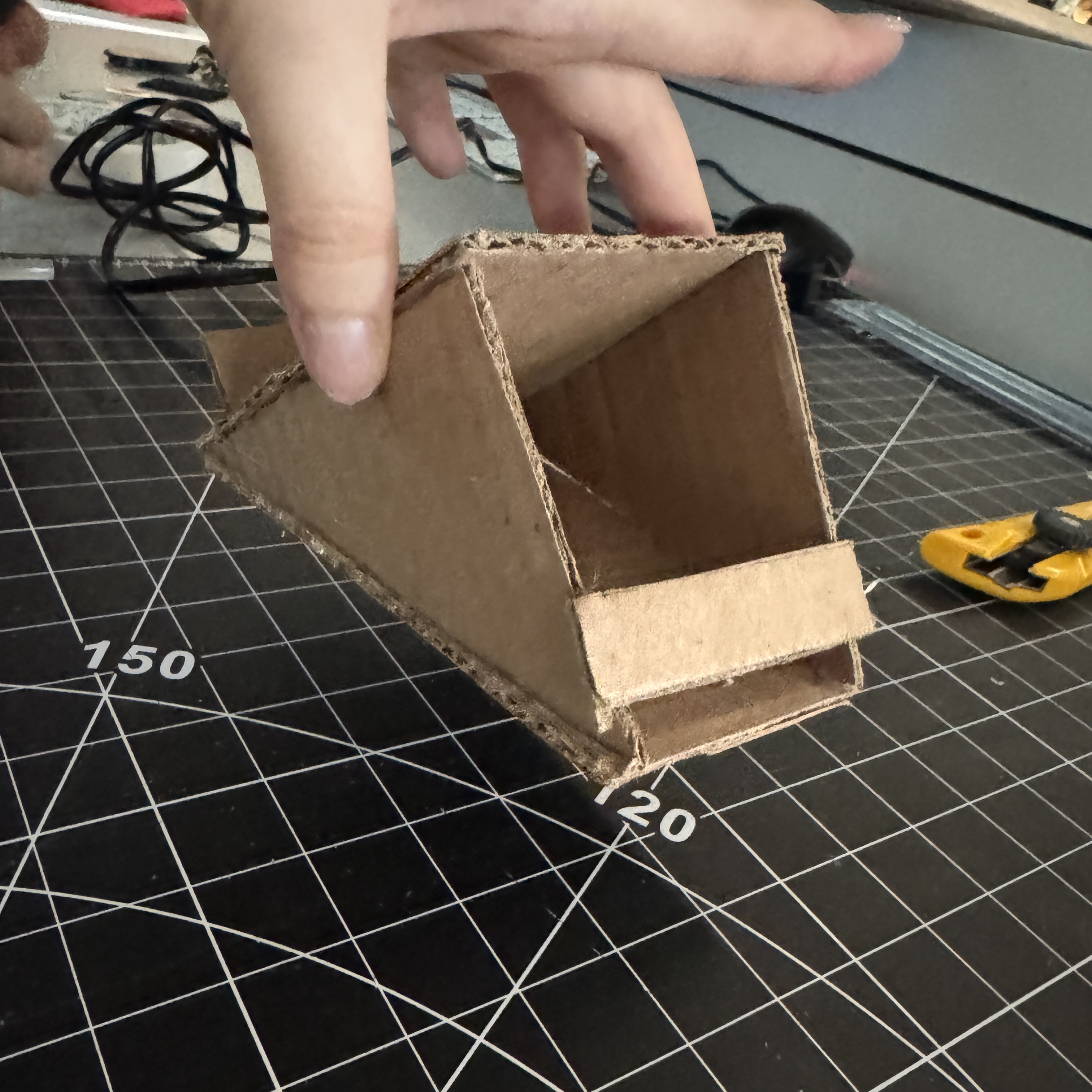 We iterated and added a piece of cardboard on the bottom to make it more stable.
